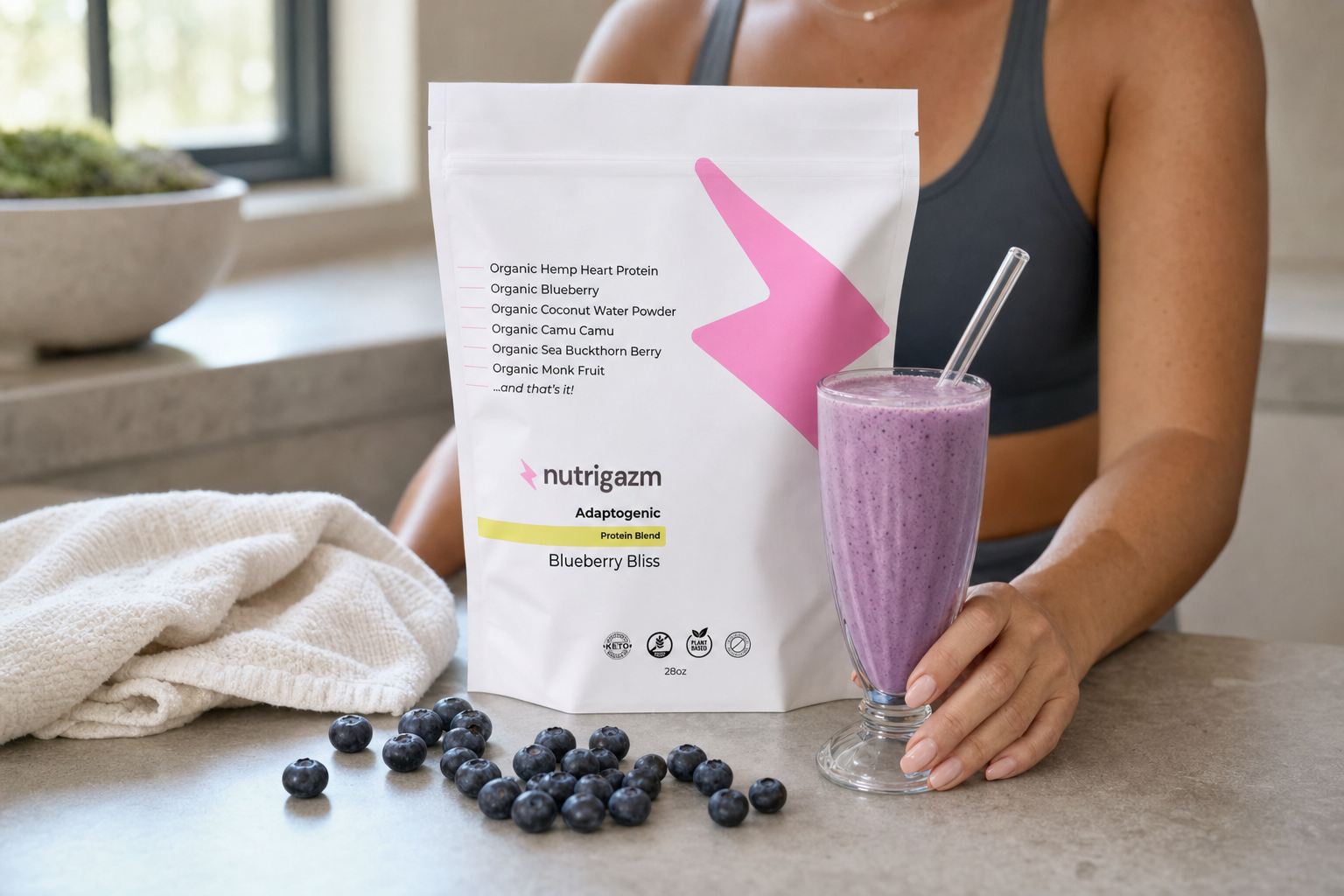 Blueberry Nutrigazm pouch beside a blueberry smoothie in natural recovery-focused lighting